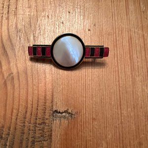 White, red, black brooch